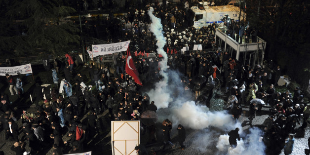 Riot police use tear gas against people gathered in support of Turkey's largest-circulation newspaper Zaman at its headquarters in Istanbul, Friday, March 4, 2016. The police raid came hours after a court placed it under the management of trustees on Friday. The move against the paper, which is linked to an opposition cleric, heightened concerns over deteriorating press freedoms in the country. (AP Photo)