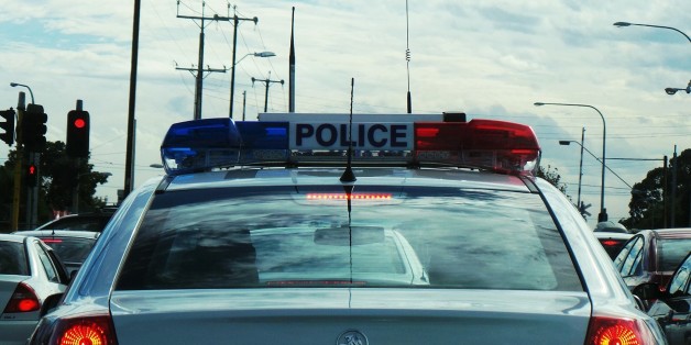 Behind a police car at the traffic lights. Hoping that they aren't gonna tell me off for doing photography while waiting for the lights to change. Not quite in the same league as texting while driving!
