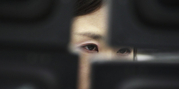 FILE - In this Tuesday, Feb. 4, 2014, file photo, a currency trader watches monitors at the Korea Exchange Bank headquarters in Seoul, South Korea. The Treasury Department reports on foreign holdings of U.S. debt for November 2015, on Tuesday, Jan. 19, 2016. (AP Photo/Ahn Young-joon, File)
