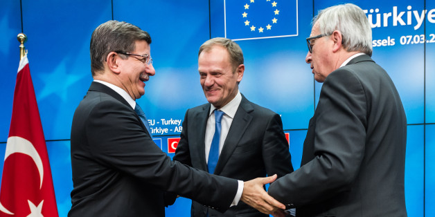 Turkish Prime Minister Ahmet Davutoglu, left, shakes hands with European Commission President Jean-Claude Juncker, right, and European Council President Donald Tusk, center, after a final media conference at an EU summit in Brussels on Tuesday, March 8, 2016. European Union leaders said early Tuesday they reached the outlines for a possible deal with Ankara to return thousands of migrants to Turkey and said they were confident a full agreement could be reached at a summit next week. (AP Photo/Geert Vanden Wijngaert)