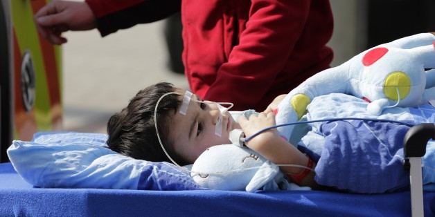 5-year-old Ashya King is loaded into an ambulance after first proton beam treatment of his brain tumor at Proton Therapy Center in Prague, Czech Republic, Monday, Sept. 15, 2014. Ashyaâs parents have fought a protracted battle to get their son treated with proton beam technology, which targets tumors more directly than radiotherapy but is not yet available for patients with brain tumors in Britain. (AP Photo/Petr David Josek)