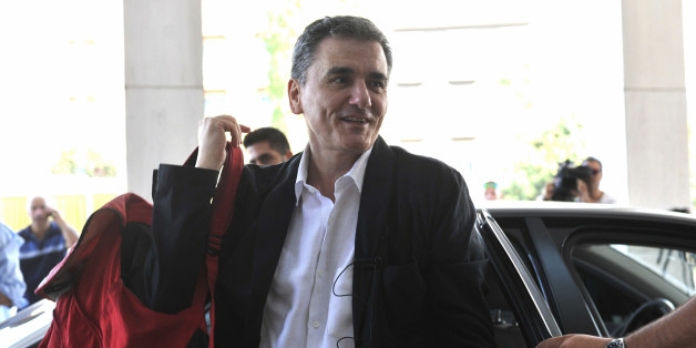 In this Friday, July 31, 2015 file photo, Greek Finance Minister Euclid Tsakalotos arrives for a meeting with senior negotiators at a hotel in Athens. Greece has essentially concluded its bailout talks with its creditors, with just a few details remaining for the deal to be formally clinched, Greek officials said Tuesday, Aug. 11. (Giannis Kotsiaris/InTime News via AP, File) GREECE OUT