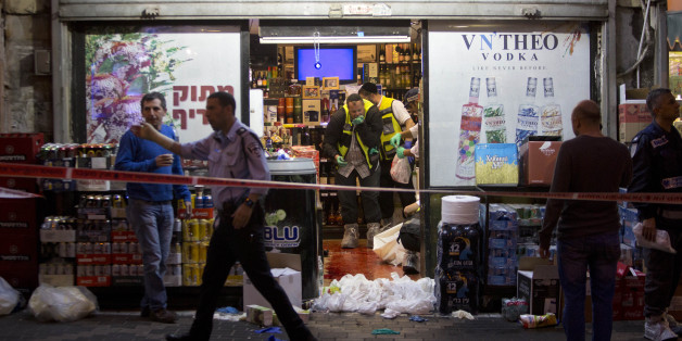 Israeli ZAKA emergency response members are seen at the scene of a stabbing attack in the central Israeli city of Petah Tikvah, Tuesday, March 8, 2016. A Palestinian opened fire at Israeli police officers outside Jerusalem's Old City on Tuesday, seriously wounding two of them before being shot dead, police said. Another Palestinian was shot dead after attacking Israeli security forces with a knife in the Old City, and a third was shot and killed after stabbing an Israeli in the central city of Petah Tikvah, according to police. (AP Photo/Sebastian Scheiner)