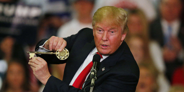 Republican presidential candidate Donald Trump holds up a key to the city he brought onto stage with him as he speaks at a campaign rally Monday, March 7, 2016, in Madison, Miss. (AP Photo/Brynn Anderson)