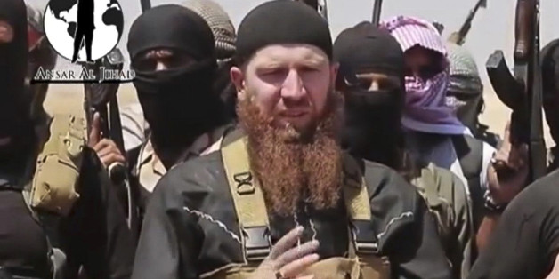 This image made from undated video posted during the weekend of June 28, 2014 on a social media account frequently used for communications by the Islamic State of Iraq and the Levant (ISIL), which has been verified and is consistent with other AP reporting, shows Omar al-Shishani standing next to the group's spokesman among a group of fighters as they declare the elimination of the border between Iraq and Syria. Al-Shishani, one of hundreds of Chechens who have been among the toughest jihadi fig