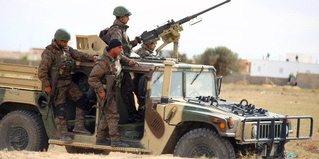 Tunisian soldiers patrol as they search for attackers still at large in the outskirts of Ben Guerdane, southern Tunisia, Tuesday, March 8, 2016. The death toll from clashes between Tunisian forces and extremist attackers near the Libyan border has risen to 55, including 36 attackers, Tunisian Prime Minister Habid Essid said Tuesday. (AP Photo)