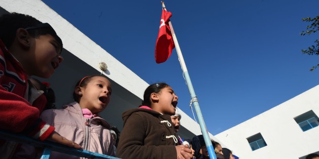 Tunisian schoolchildren sing their national anthem in a primary school in the Tunis suburb of Ariana on March 9, 2016 after having observed a minute of silence for the victims of attacks blamed on the Islamic State group that left dozens dead.
Tunisian forces repelled a jihadist assault on a town near the Libyan border, killing 36 assailants in what authorities said was a thwarted effort to establish an Islamic emirate. Eleven members of the security forces and seven civilians were also killed in Ben Guerdane in what President Beji Caid Essebsi condemned as an 'unprecedented' jihadist attack.
/ AFP / FETHI BELAID (Photo credit should read FETHI BELAID/AFP/Getty Images)