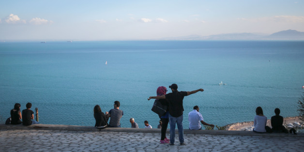 Couples observe a panoramic view of the Gulf of Tunis from the touristic village of Sidi Bou Said, some 20 kilometers outside of Tunis, Tunisia, Tuesday, Oct. 27, 2015. (AP Photo/Mosa'ab Elshamy)