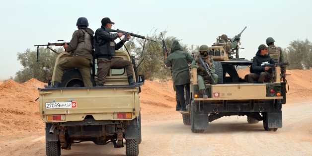 Members of the Tunisian military patrol a road near the Libyan border on March 10, 2016 in Bouhamed, 40 km from the town of Ben Guerdane, as they continue hunting jihadists in the area.
A nighttime curfew and tight security remain in place in Tunisia's Ben Guerdane area after clashes with jihadists that left dozens dead. / AFP / FATHI NASRI (Photo credit should read FATHI NASRI/AFP/Getty Images)