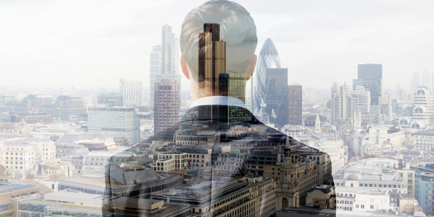 Double exposure of a business man looking towards the financial district of the City of London with the Heron Tower, Tower 42 and the Gherkin.