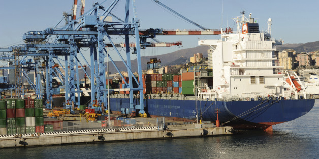 'Large modern container boat arriving at the dock, several elevators ready for unloading, Genoa, Italy'
