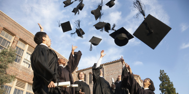 Graduates throwing hats in the air
