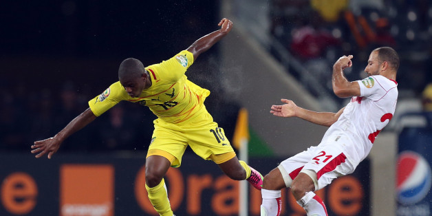 Togo's Floyd Ayite, left, is challenged by Tunisia's Khaled Mouelhi, right, during their African Cup of Nations Group D soccer match at Mbombela Stadium in Nelspruit, South Africa, Wednesday Jan. 30, 2013. (AP Photo/Themba Hadebe)