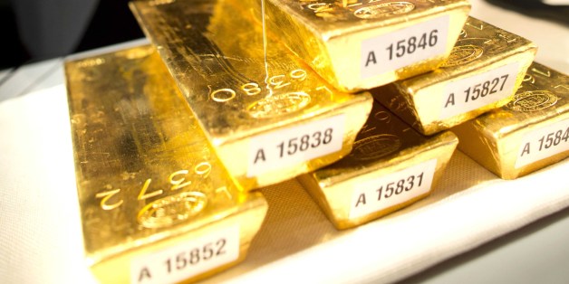 A bank employee meassures a gold ingot during a press conference at the German central bank in Frankfurt, Germany, Wednesday Jan. 16, 2013. Germany's central bank is to bring back home some US $36 billion ( 27 billion euro) worth of gold stored in the United States and France. The Bundesbank said in a statement Wednesday that it will repatriate all 374 tons of gold it had stored in Paris by 2020. An additional 300 tons - equivalent to 8 percent of the Bundesbank's total reserves worth about U