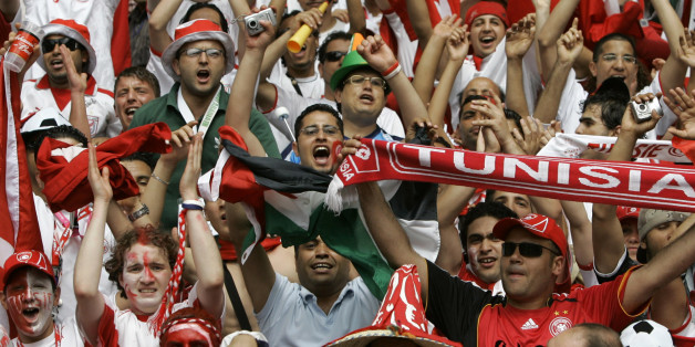 Fans for Tunisia cheer prior to the start of the Ukraine v Tunisia Group H World Cup soccer match at the Olympic Stadium, Berlin, Germany, Friday, June 23, 2006. The other teams in Group H are Spain and Saudi Arabia. (AP Photo/Armando Franca) ** MOBILE/PDA USAGE OUT **