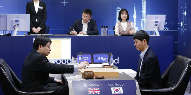 South Korean professional Go player Lee Sedol, right, watches as Google DeepMind's lead programmer Aja Huang, left, puts the Google's artificial intelligence program, AlphaGo's first stone during the final match of the Google DeepMind Challenge Match in Seoul, South Korea, Tuesday, March 15, 2016. A champion Go player scored his first win over a Go-playing computer program on Sunday after losing three straight times in the ancient Chinese board game, saying he finally found weaknesses in the software. (AP Photo/Lee Jin-man)