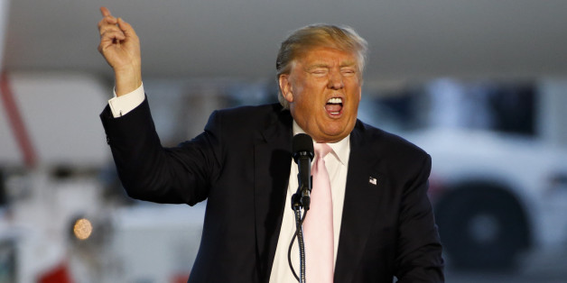Republican presidential candidate, Donald Trump holds a plane-side rally in a hanger at Youngstown-Warren Regional Airport in Vienna, Ohio, Monday, March 14, 2016. (AP Photo/Gene J. Puskar)