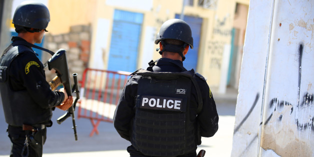 Tunisian police officers take positions as they search for attackers still at large in the outskirts of Ben Guerdane, southern Tunisia, Tuesday, Match 8, 2016. The death toll from clashes between Tunisian forces and extremist attackers near the Libyan border has risen to 55, including 36 attackers, Tunisian Prime Minister Habid Essid said Tuesday. (AP Photo/Feres Najar)