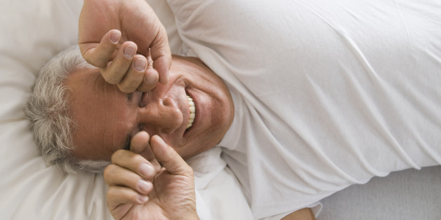 portrait of mature man awaking rubbing his eyes