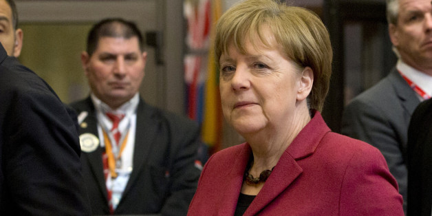 German Chancellor Angela Merkel, center, leaves an EU summit in Brussels on Friday, March 18, 2016. European Union leaders struggled to reach a deal Thursday that balanced their concerns about refugee law and Turkeyâs human rights record with their desperation to halt the migrant crisis. (AP Photo/Virginia Mayo)