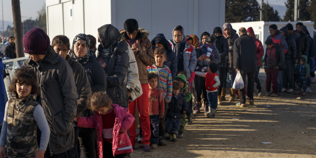 IDOMENI, GREECE - MARCH 19: Migrants queue for food at the Idomeni refugee camp on the Greek Macedonia border on March 19, 2016 in Idomeni, Greece. Thousands of migrants remain stranded at the border camp following high hopes that yesterday's EU summit would have brought them some sort of resolution. The decision by Macedonia to close its border to migrants last week followed the lead taken by neighbouring countries, effectively sealed the so-called western Balkan route, the main migration route that has been used by hundreds of thousands of migrants to reach countries in western Europe such as Germany. Humanitarian workers have described the conditions at the camp as desperate, which has been made much worse by recent spells of heavy rain. (Photo by Carsten Koall/Getty Images)