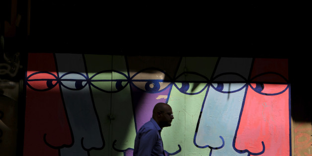 A pedestrian walks in front of a mural in central Athens, Monday, Aug. 26, 2013. In two bailout packages so far, Greece's European partners and the International Monetary Fund have committed euro 240 billion (US$320 billion) in loans. Last week, German Finance Minister Wolfgang Schaeuble said there will have to be another aid program after the current one expires next year. (AP Photo/Petros Giannakouris)