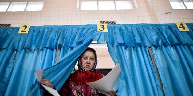 A woman votes during parliamentary elections in the Kazakh city of Baikonur, also known as Russian-leased Baikonur cosmodrom, about 1,400 km from Kazakh capital Astana on March 20, 2016.
Citizens of energy-rich Kazakhstan went to the polls in an early parliamentary election expected to provide a commanding majority for ageing autocrat President Nursultan Nazarbayev's ruling Nur Otan party.
/ AFP / KIRILL KUDRYAVTSEV (Photo credit should read KIRILL KUDRYAVTSEV/AFP/Getty Images)