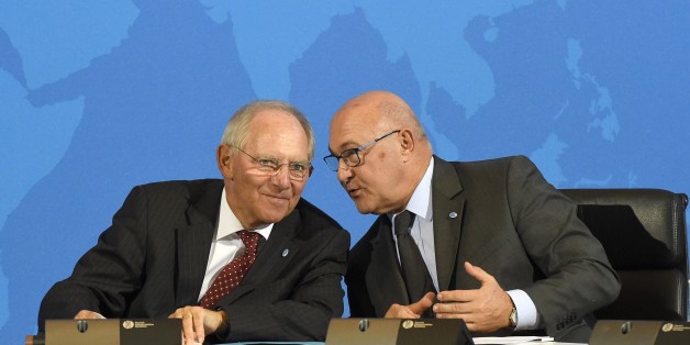 (LtoR) German Finance Minister Wolfgang Schaeuble and French Finance Minister Michel Sapin chat during a press conference after the signing of the Multilateral Competent Authority Agreement by more than 80 countries on October 29, 2014 in Berlin, as part of the Berlin Tax Conference. The agreement could put an end to banking secrecy in the global battle against tax evasion and fraud.
AFP PHOTO / TOBIAS SCHWARZ (Photo credit should read TOBIAS SCHWARZ/AFP/Getty Images)