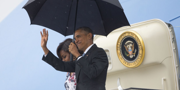 President Barack Obama, right, arrives with first lady Michelle Obama as they exit Air Force One at the airport in Havana, Cuba, Sunday, March 20, 2016. Obama's trip is a crowning moment in his and Cuban President Raul Castro's ambitious effort to restore normal relations between their countries. (AP Photo/Pablo Martinez Monsivais)