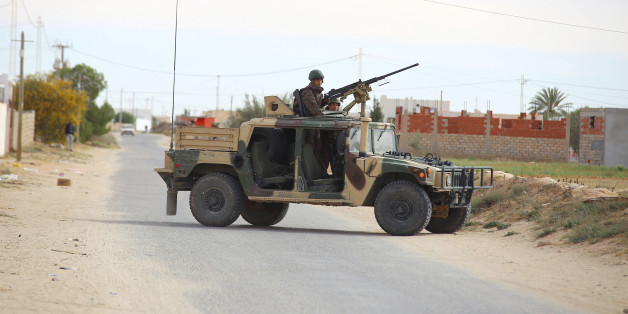 Tunisian soldiers ride an humvee as they search for attackers still at large in the outskirts of Ben Guerdane, southern Tunisia, Tuesday, March 8, 2016. (AP Photo)