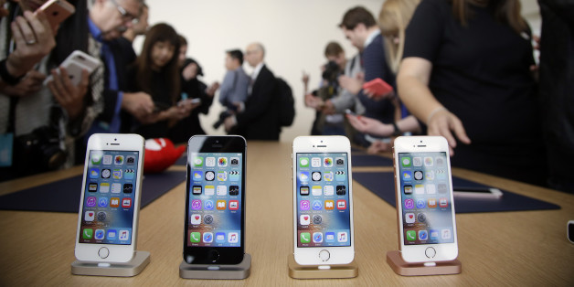 Members of the media and invited guests take a look at the new iPhone SE during an event at Apple headquarters Monday, March 21, 2016, in Cupertino, Calif. (AP Photo/Marcio Jose Sanchez)