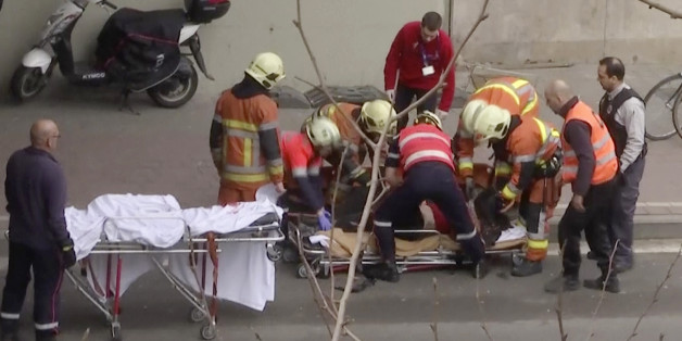 In this image made from video, emergency rescue workers stretcher an unidentified person at the site of an explosion at a metro station in Brussels, Belgium, March 22, 2016. Explosions rocked the Brussels airport and the subway system Tuesday, just days after the main suspect in the November Paris attacks was arrested in the city, police said.(APTN via AP)