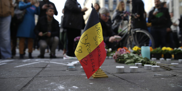 A Belgian flag reading 'We are all Brussels' stands at a makeshift memorial at Place de la Bourse (Beursplein) following attacks in Brussels on March 22, 2016. Airlines cancelled hundreds of flights and European railways froze links with Brussels after a series of bomb blasts killed around 35 people in the city's airport and a metro train, sparking a broad security response. AFP PHOTO / KENZO TRIBOUILLARD / AFP / KENZO TRIBOUILLARD (Photo credit should read KENZO TRIBOUILLARD/AFP/Getty Images)