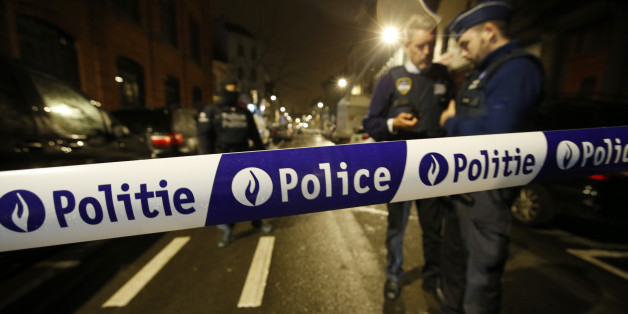 Police guard a check point during a police raid in the suburb of Schaerbeek in Brussels, Thursday, March, 24, 2016. Belgium's prime minister refused to accept the resignations of his justice and interior ministers Thursday despite increasing evidence of intelligence and law enforcement failures to prevent this week's suicide bombings by Islamic militants. (AP Photo/Alastair Grant)
