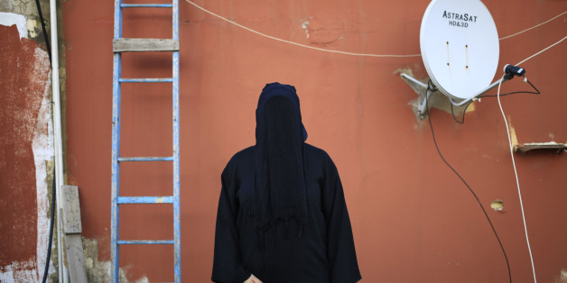 This Friday, May 1, 2015 shows a 32-year old Lebanese woman, whose father is a Shiite Muslim and mother is a Sunni Muslim, posing for a photograph, on the roof of her home in Beirut, Lebanon. For most, the niqab is a choice. They do so out of their own interpretation of the Quran and the hadith, a collection of traditions and anecdotes about the Prophet Muhammad, believing that a womanâs body should be covered out of modesty. (AP Photo/Hassan Ammar)