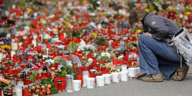 A woman lights a candle on March 19, 2009 in front of the Albertville secondary school in Winnenden, southern Germany, where a teenager went on the rampage one week ago. On March 11, 2009 teenager Tim K. used his father's pistol to kill 15 people and himself. AFP PHOTO DDP/OLIVER LANG GERMANY OUT (Photo credit should read OLIVER LANG/AFP/Getty Images)