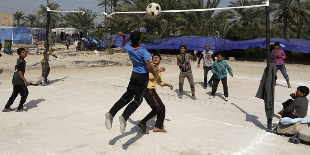 Teenagers who fled from Tikrit, Iraq, because they feared Islamic State militants play volleyball at a refugee camp outside Baghdad, Iraq, Wednesday, March 18, 2015. (AP Photo/Karim Kadim)