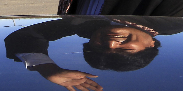 Bolivia's President Evo Morales is reflected on a car as he waves while leaving a charity event, in Lescar, near Pau, southwestern France, Saturday, Nov. 7, 2015. Morales is on a two day visit to France and will meet with French President Francois Hollande in Paris on Monday. (AP Photo/Bob Edme)