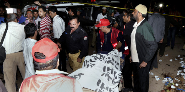 Pakistani rescue workers remove a dead body from the site of bomb blast in a park in Lahore, Pakistan, Sunday, March, 27, 2016. A bomb blast in a park in the eastern Pakistani city of Lahore has killed tens of people and wounded scores, a health official said. (AP Photo/K.M. Chuadary)