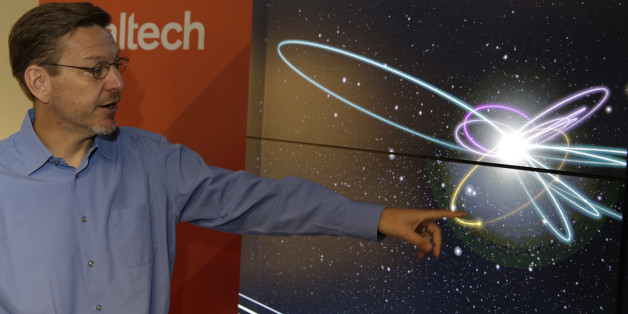 California Institute of Technology astronomer Michael Brown points to a yellow dot simulating Planet 9 on a computer video simulation view of Planet 9 in the solar system at the CalTech USGS Media center in Pasadena, Calif., on Wednesday, Jan. 20, 2016. Scientists reported Wednesday, they finally have "good evidence" for Planet 9, a true ninth planet on the fringes of our solar system. The gas giant is thought to be almost as big as Neptune and orbiting billions of miles beyond Neptune's path, distant enough to take 10,000 to 20,000 years to circle the sun. Planet 9, as the two Caltech researchers call it, hasn't been spotted yet. They base their findings on mathematical and computer modeling, and anticipate its discovery via telescope within five years. (AP Photo/Damian Dovarganes)