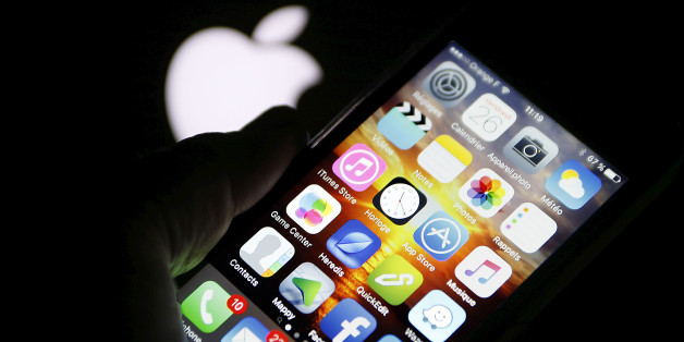 An Apple iPhone is pictured next to the logo of Apple in Bordeaux, southwestern France, February 26, 2016. REUTERS/Regis Duvignau
