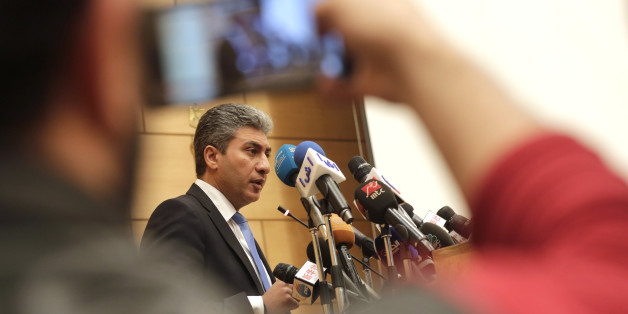 Egyptian Minister of Civil Aviation Sharif Fathy speaks during a press conference at the Ministry headquarters in Cairo, Egypt, Tuesday, March 29, 2016. Fathy said seven people remain with the hijacker on the EgyptAir plane that has landed in Cyprus, four crew and three passengers. (AP Photo/Amr Nabil)
