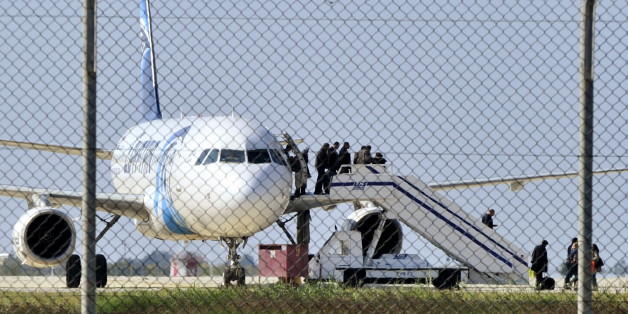 Passengers evacuate a hijacked EgyptAir Airbus 320 plane at Larnaca airport, Cyprus, March 29, 2016. REUTERS/Stringer EDITORIAL USE ONLY. NO RESALES. NO ARCHIVE