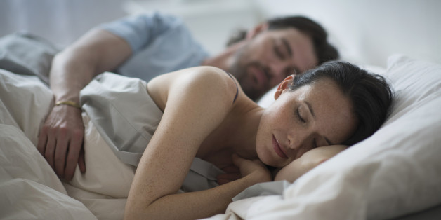 USA, New Jersey, Couple sleeping together in bed at night