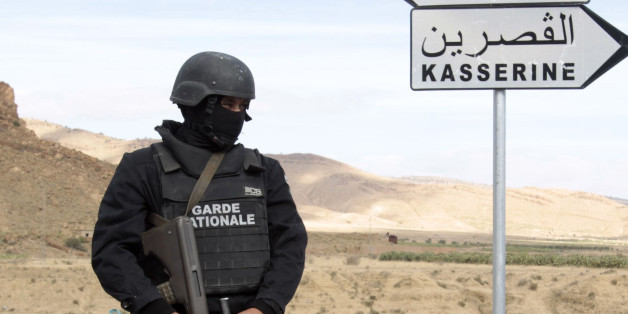A Tunisian police stands with a weapon near a mountain in Kasserine October 23, 2014. The Chaambi, Saloum and Sammama mountains bordering with Algeria have become a refuge for militant groups over the past two years, turning Kasserine into a military barracks encircled by roadblocks to curb attacks. Picture taken October 23. To match story TUNISIA-ELECTION/ REUTERS/Zoubeir Souissi (TUNISIA - Tags: POLITICS CIVIL UNREST)