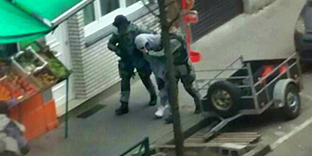 THIS IMAGE IS BINNED A suspect is apprehended by armed Belgian police in Molenbeek, near Brussels, Belgium, in this still image taken from video shot on March 18, 2016. Belgian-born Salah Abdeslam, one of the main suspects from November's Paris attacks, was arrested after a shootout with police in Brussels on Friday. REUTERS/iTele via Reuters TV ATTENTION EDITORS - THIS PICTURE WAS PROVIDED BY A THIRD PARTY. REUTERS IS UNABLE TO INDEPENDENTLY VERIFY THE AUTHENTICITY, CONTENT, LOCATION OR D