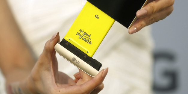 A model poses for photographs with LG Electronics' new smartphone G5 and its removable battery during its launch event in Taipei, Taiwan March 24, 2016. REUTERS/Tyrone Siu
