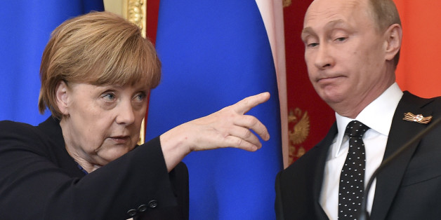 German Chancellor Angela Merkel (L) gestures as Russian President Vladimir Putin looks on during a news conference after talks at the Kremlin in Moscow, Russia, May 10, 2015. Russian President Vladimir Putin said on Sunday that a peace deal agreed in Minsk over the separatist conflict in east Ukraine was moving forward despite problems and that it had been quieter in Ukraine recently. Putin made the comments at a news conference in Moscow with Germany's Angela Merkel. REUTERS/Kirill Kudryavtsev/