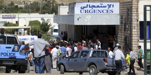 Residents gather outside the hospital of Kasserine, near the Algerian border, Thursday, July 17, 2014. Militants in western Tunisia staged two simultaneous attacks on army posts while soldiers held a Ramadan feast, killing at least 14 soldiers, authorities said Thursday. (AP Photo/ Mouldi Kraeim)