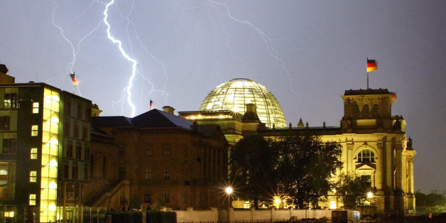 A bolt of lightning is seen during a thunderstorm over the Reichstagbuilding in Berlin late August 28, 2002. The Reichstags building is theseat of the German lower house of parliament Bundestag. REUTERS/ArndWiegmannAKW/CLH/